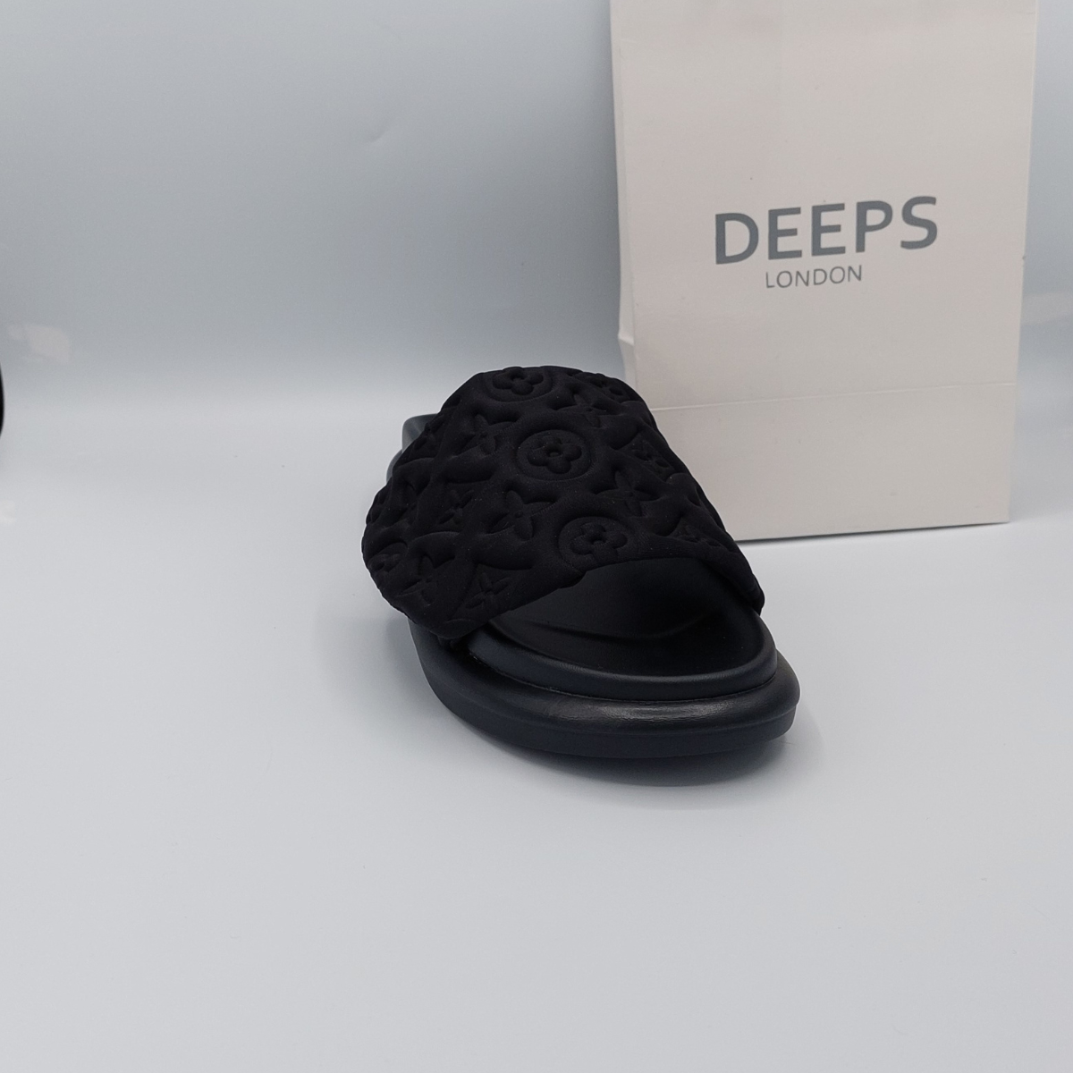 Woman's foot wearing comfortable women's velcro strap flatform slider sandal in black, perfect for everyday wear in London.