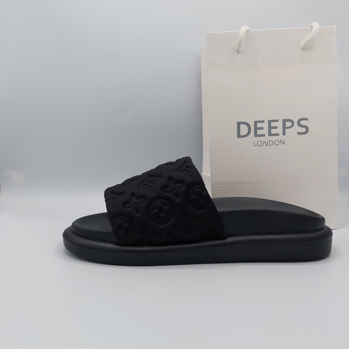Side profile of women's velcro strap flatform slider sandal in black, highlighting the supportive flatform and easy slip-on design.