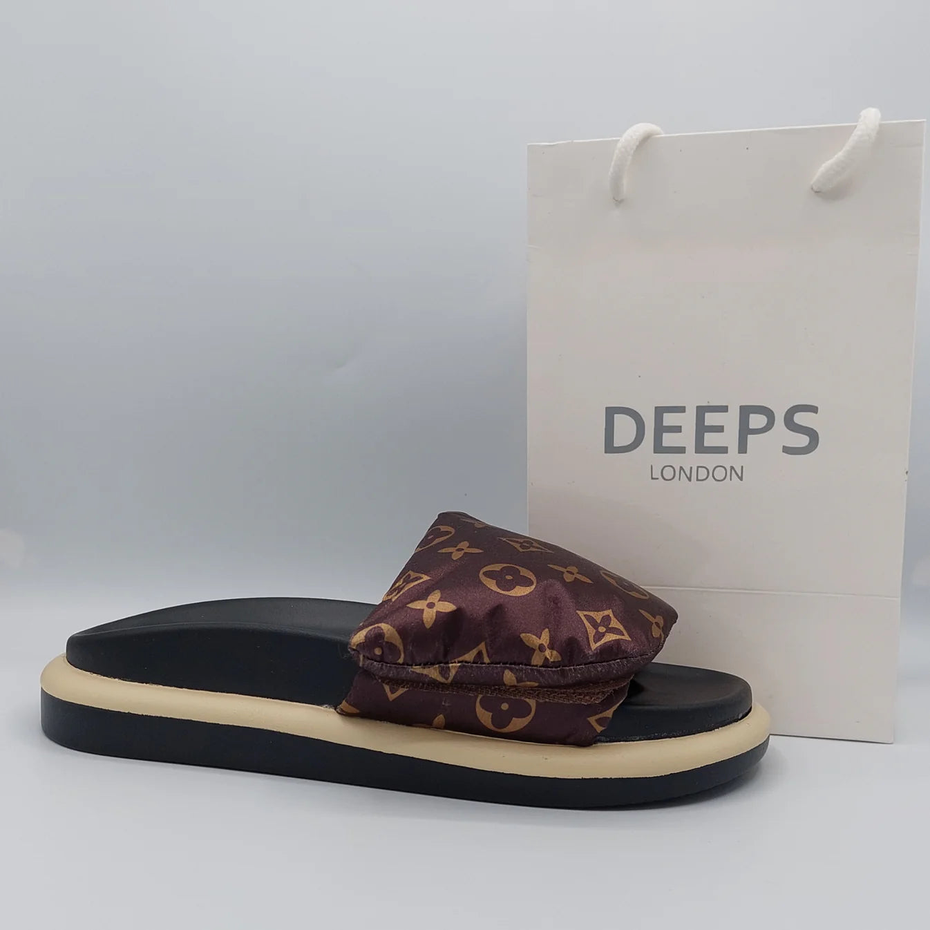 Close-up of the velcro straps and flatform sole on women's slider sandal in brown, emphasizing the comfort and adjustability.