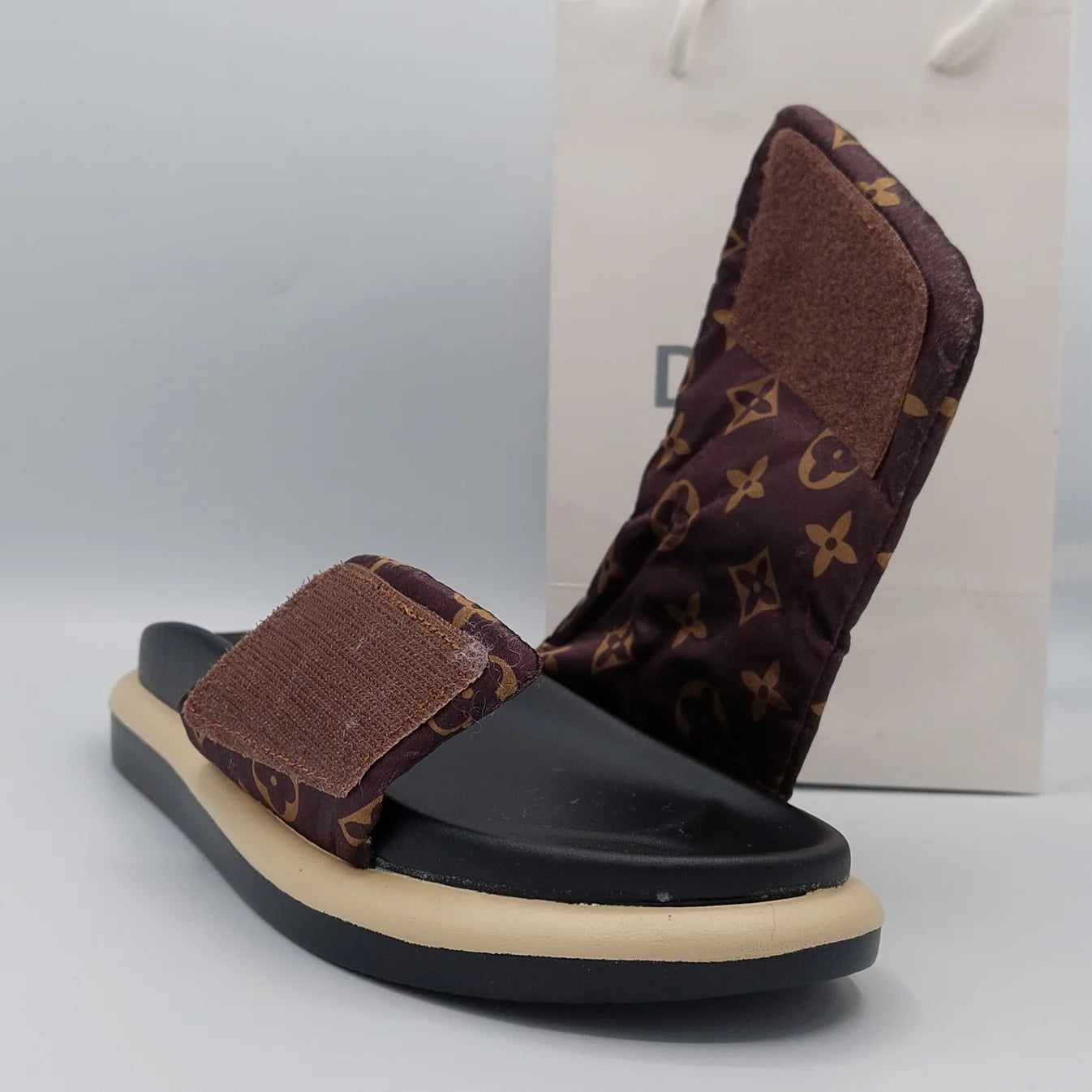 Woman's foot wearing comfortable women's velcro strap flatform slider sandal in brown, perfect for everyday wear in London.