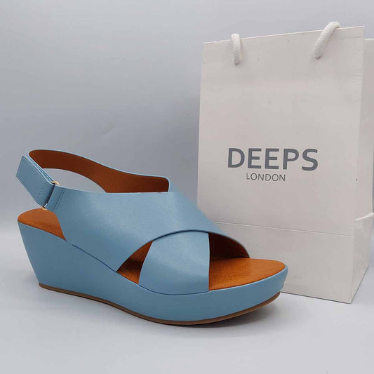 Side profile of women's wedge heel peep toe sandal in blue, showcasing the wedge heel and peep toe design for London fashion.