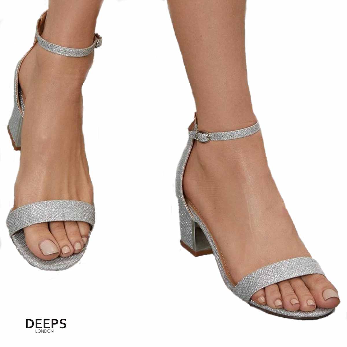 Woman's foot wearing stylish Stravelle block heel buckle strap sandals in silver shimmer, a comfortable and fashionable choice for London days from DeepsLondon.