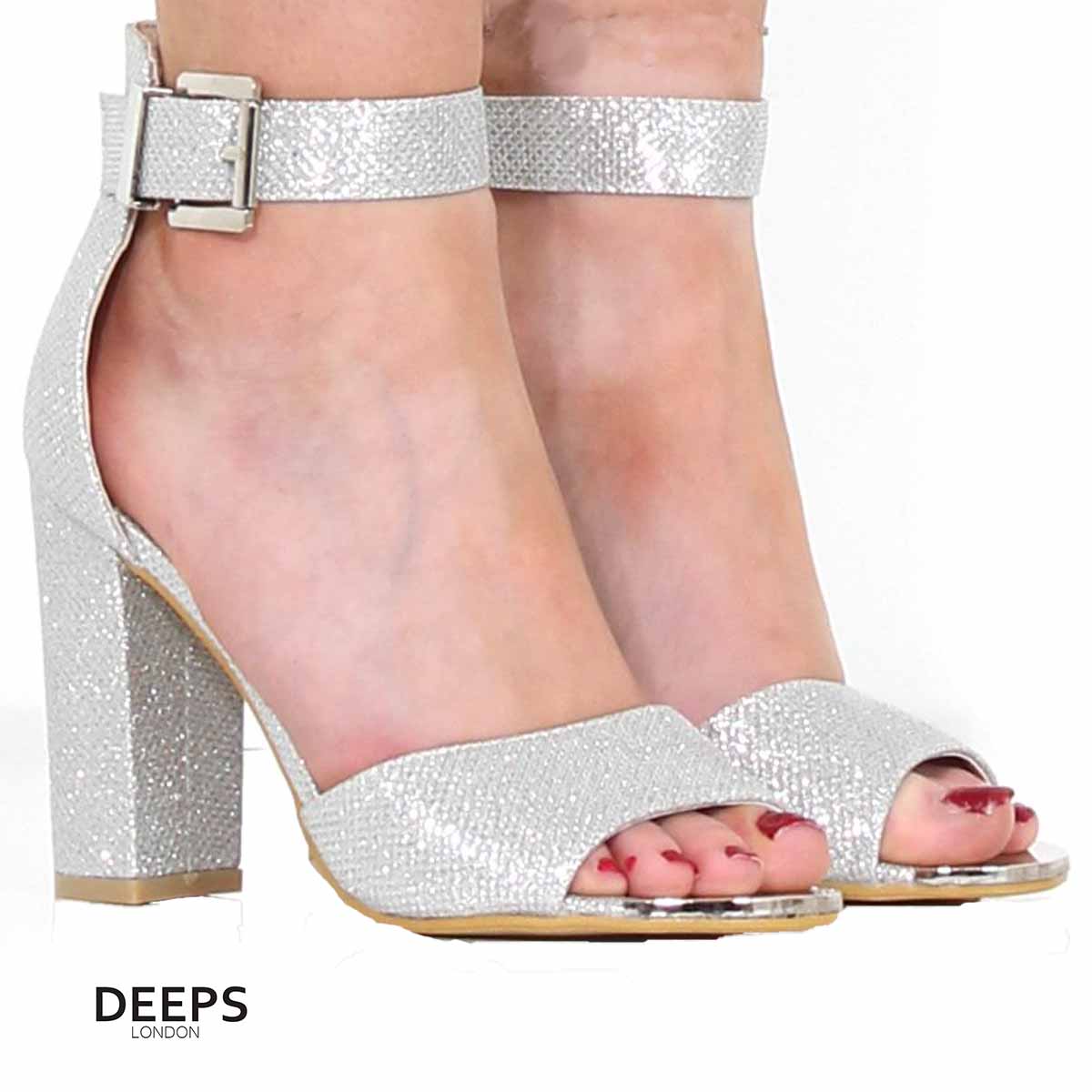 Woman's foot wearing stylish Belgravia chunky buckle strap block heel sandals (approx. 4-inch heel) in Silver, a fashionable and confident choice for London events from DeepsLondon.