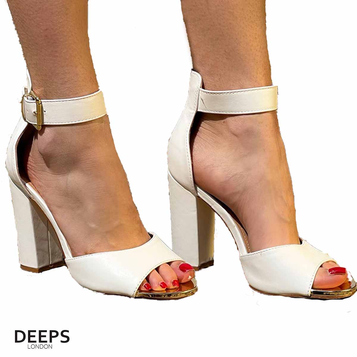 Woman's foot wearing stylish Belgravia chunky buckle strap block heel sandals (approx. 4-inch heel) in white, a fashionable and confident choice for London events from DeepsLondon.