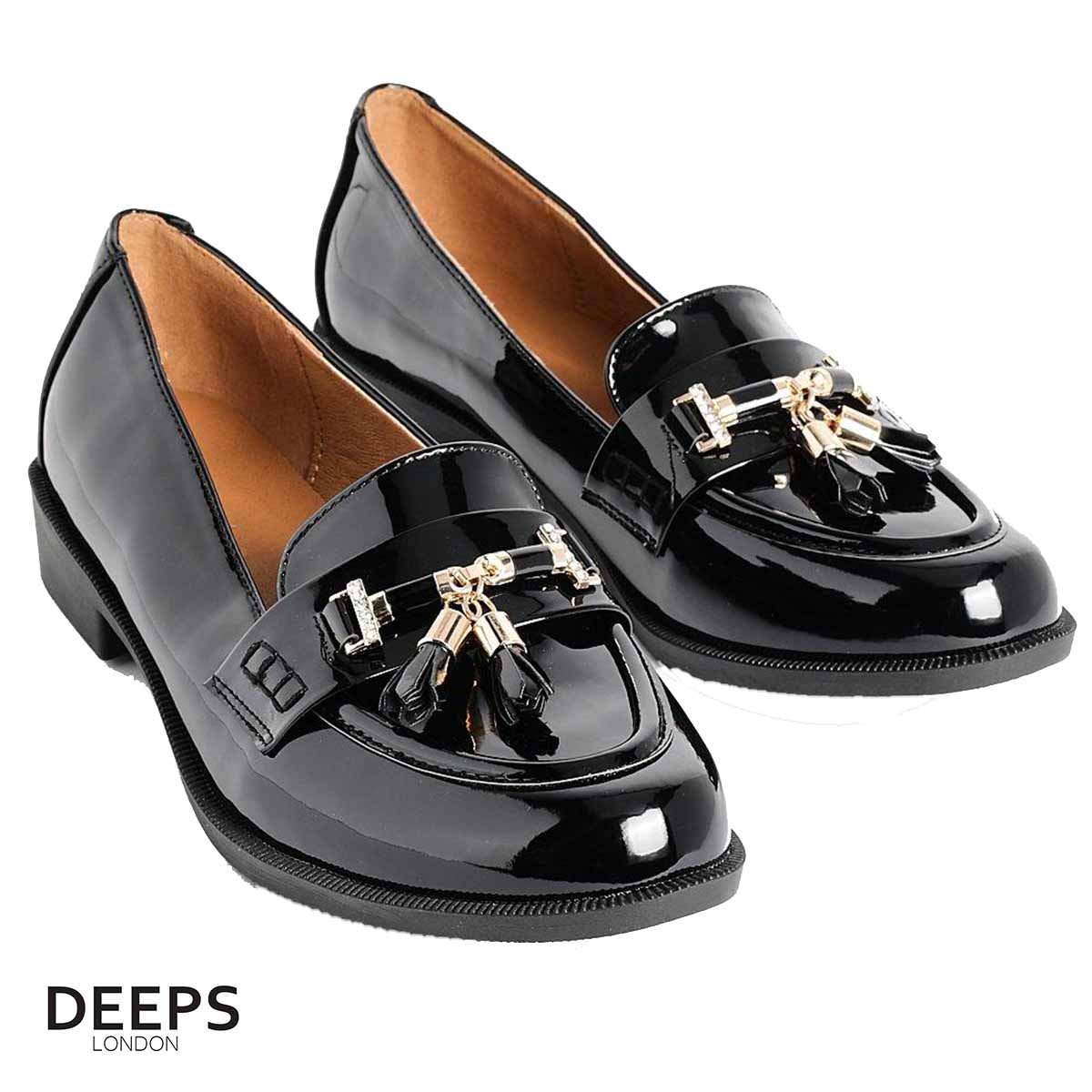 Front view of women's black classic slip-on loafer with a gold bar and tassel detail, a timeless and stylish shoe in London.