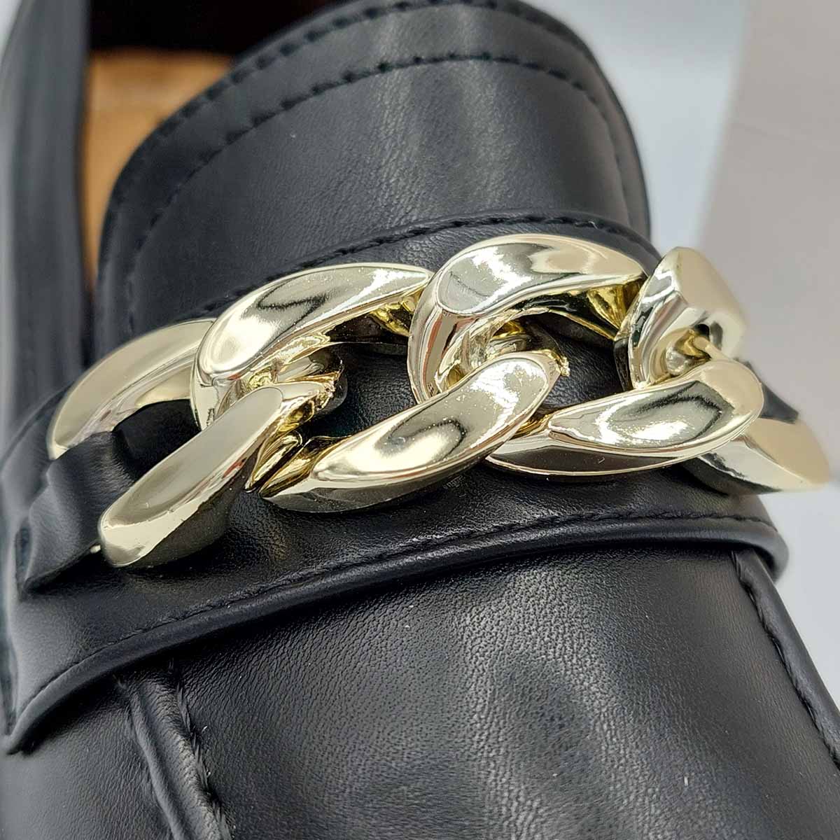 Close-up of the chunky platform sole and the bold chain detail on women's black PU loafers, highlighting their unique and fashionable features in London.