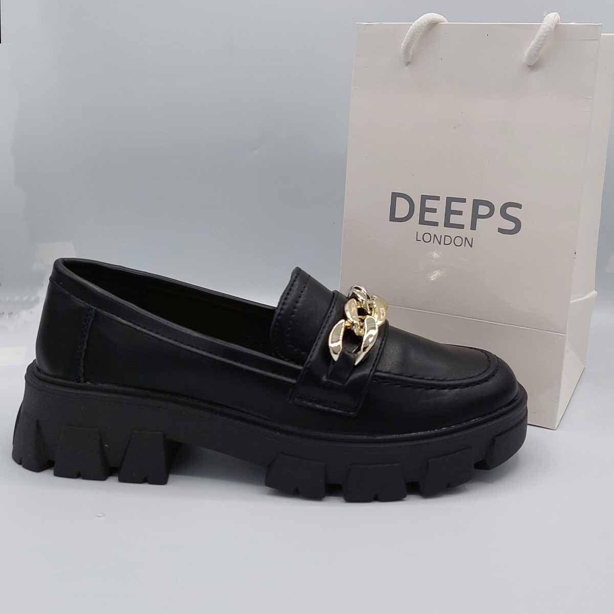 Side profile of women's black PU platform loafer featuring the chunky sole and striking chain detail, perfect for edgy yet practical London fashion.