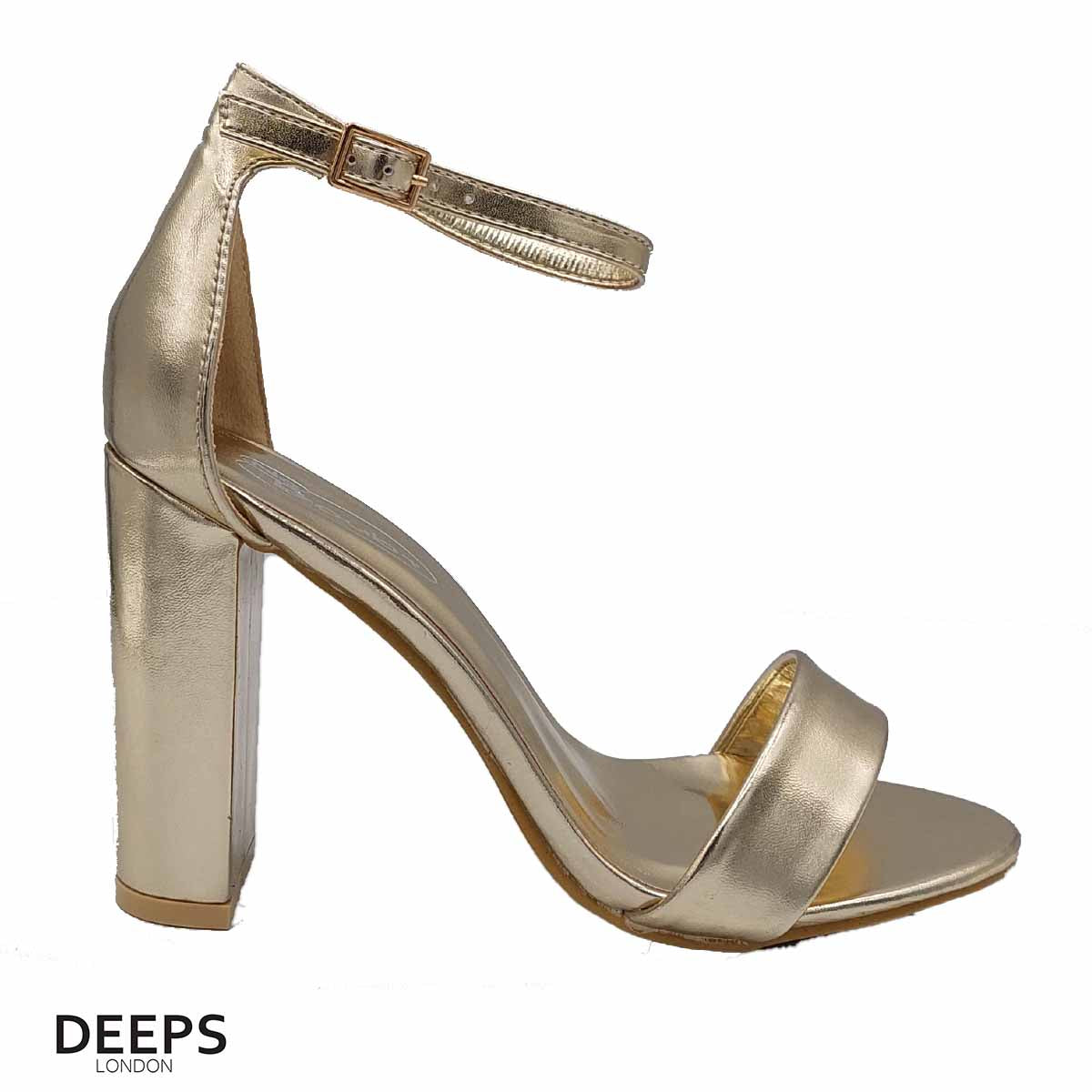 Close-up of the chunky buckle strap and block heel (approx. 9.5cm) on women's sandals in gold, highlighting their bold features from DeepsLondon.