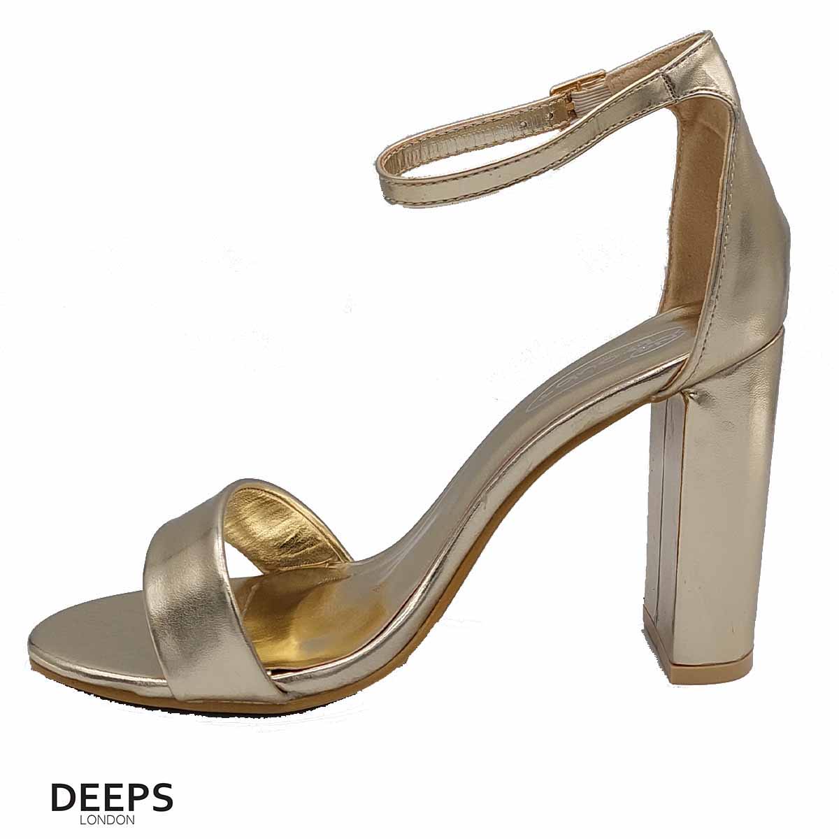 Side profile of women's chunky buckle strap block heel sandals with a 9.5cm heel in gold, showcasing the block heel and chunky buckle strap detailing for London style.