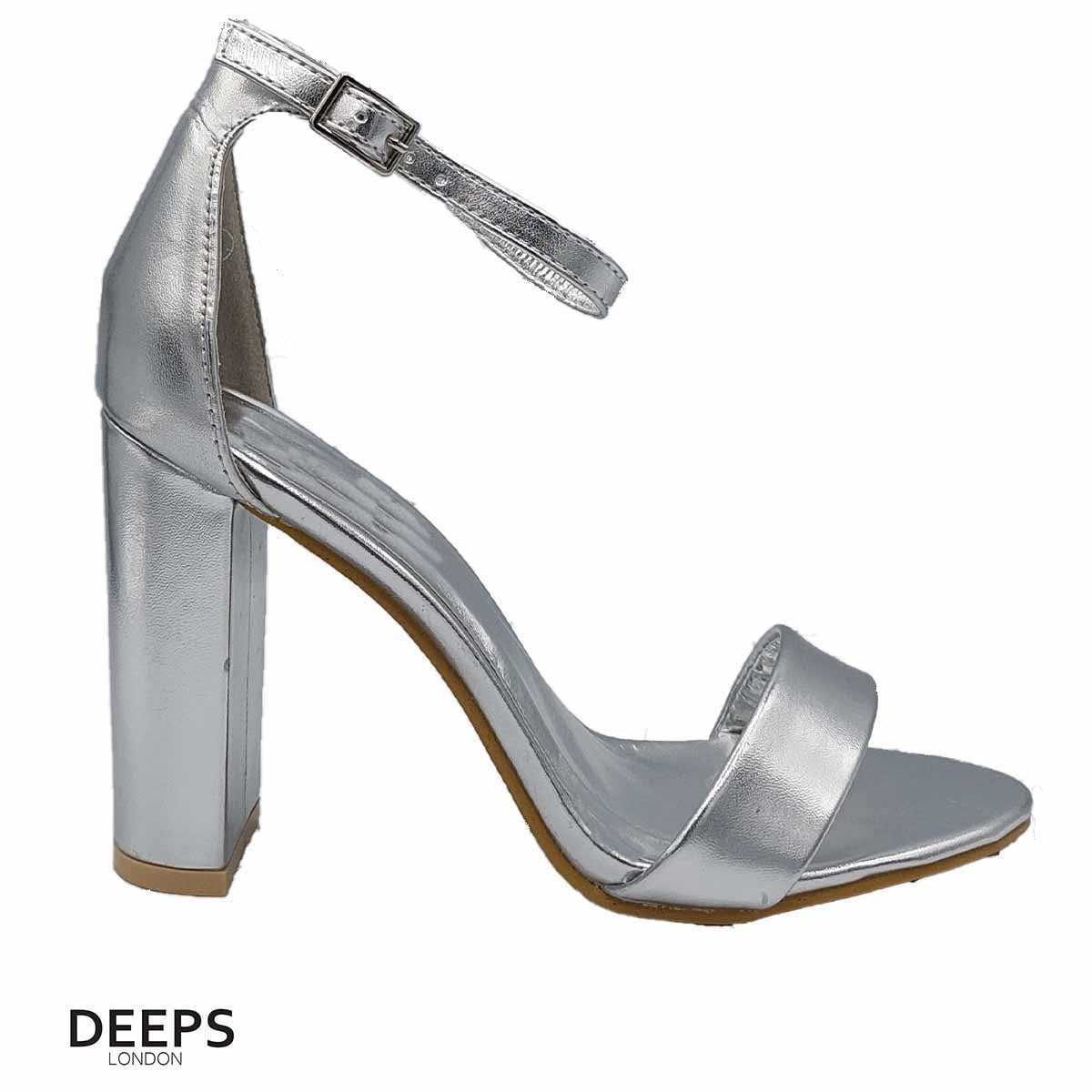 Front view of women's chunky buckle strap block heel sandals with a 9.5cm heel in silver, a statement style for London fashion from DeepsLondon.