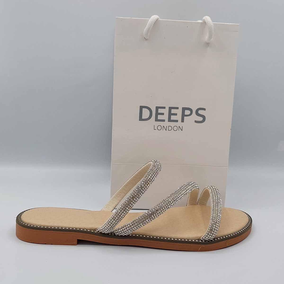 Side profile of women's cross strap embellished flat slider sandals in beige, showcasing their comfortable design and sparkling detail for London style.