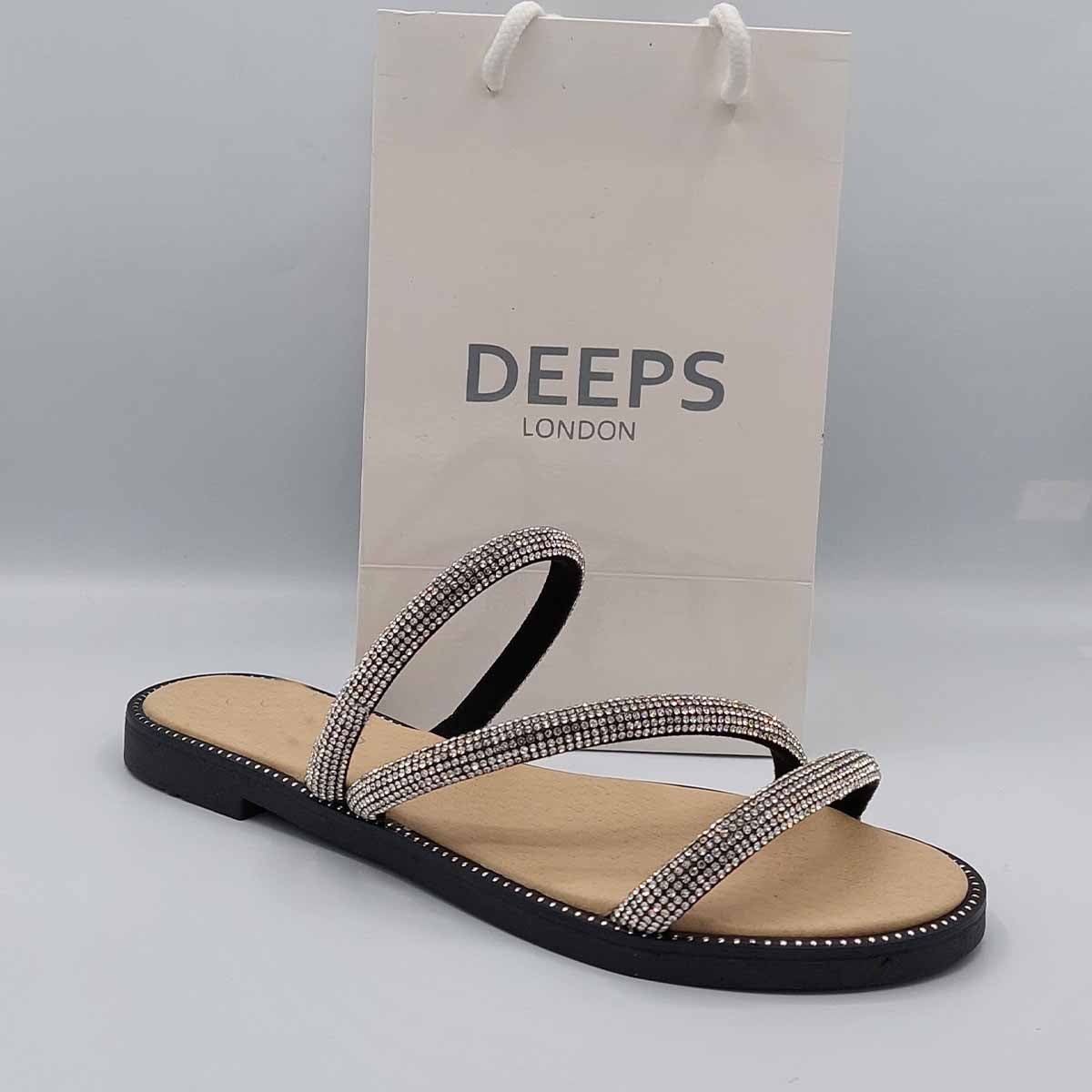 Close-up of the sparkly embellishments on the cross straps of women's flat slider sandals in black, highlighting their glamorous features from DeepsLondon.