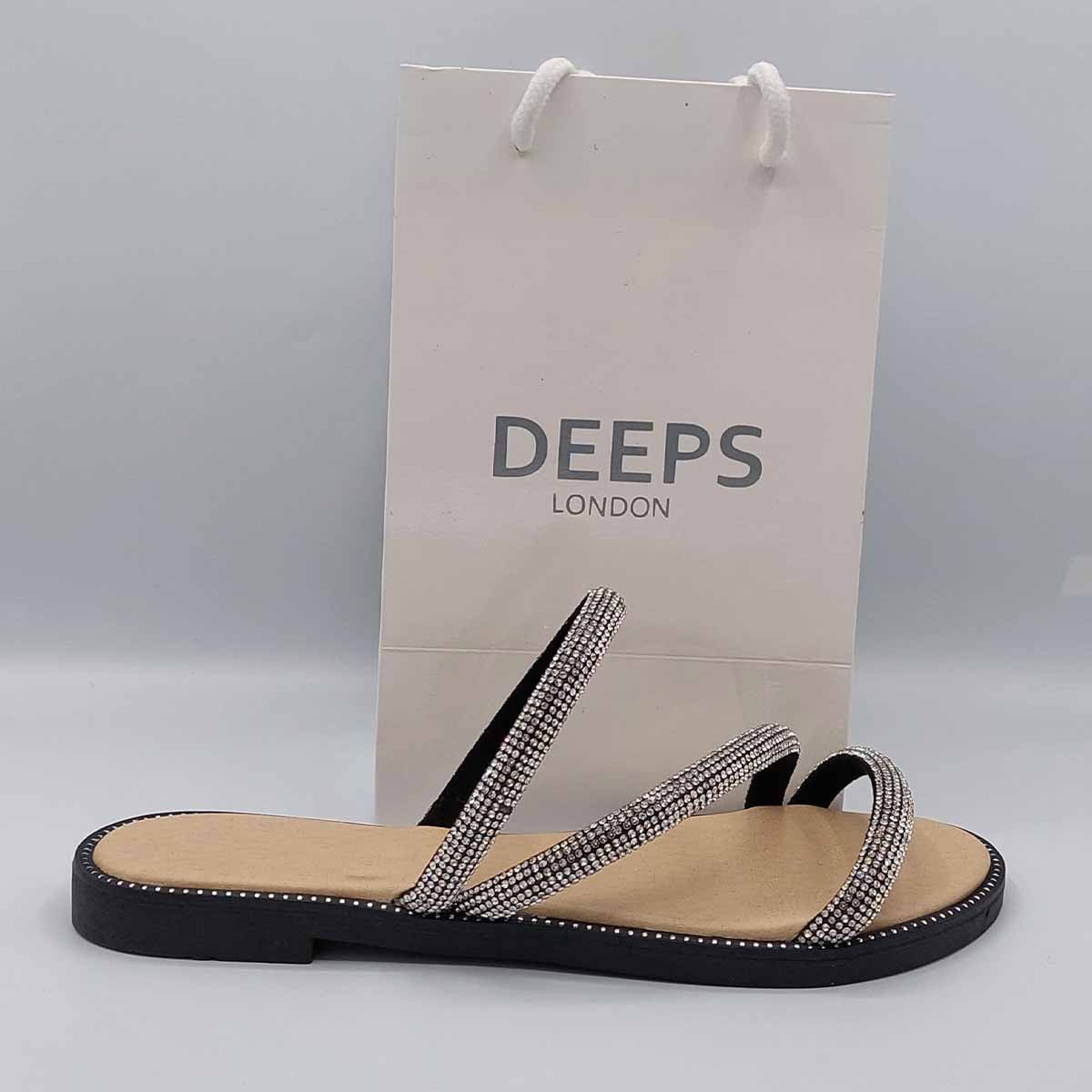 Front view of women's cross strap flat slider sandals in black with sparkly embellishments, a glamorous choice for London.
