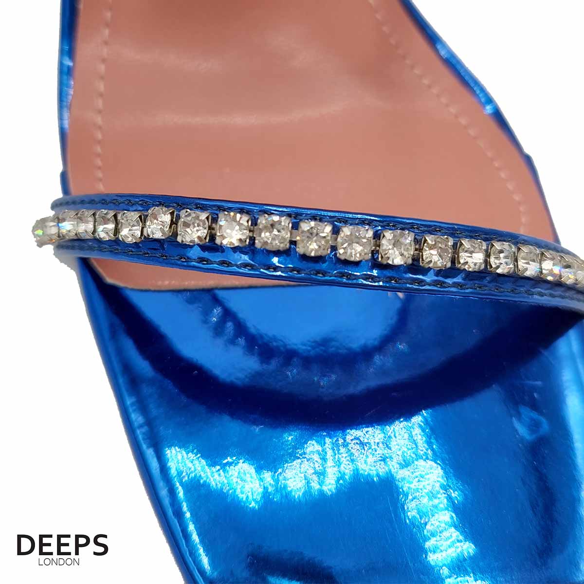 Close-up of the crystal embellishments and pyramid heel on women's sandals in royal blue, highlighting their unique and elegant features from DeepsLondon.