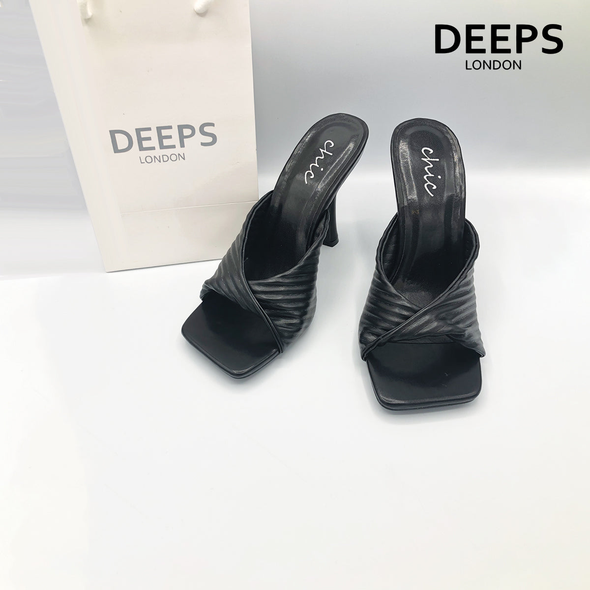 Close-up detail of Dasha folded mule ribbed high heel in black, showcasing the intricate folded and ribbed design, London style from DeepsLondon.