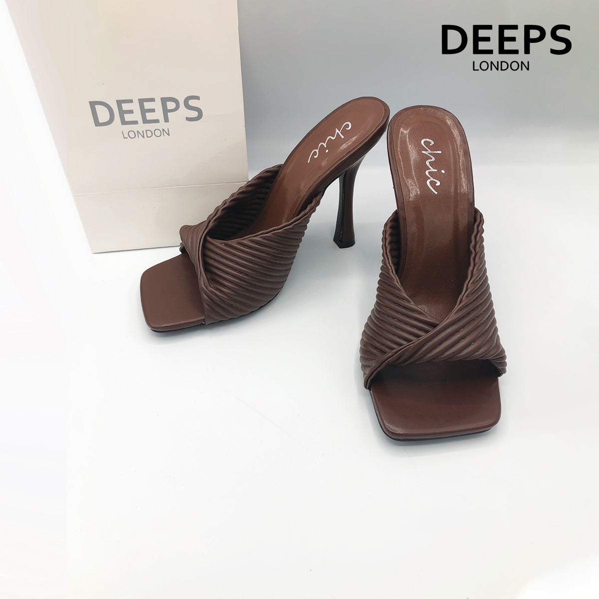 Close-up detail of Dasha folded mule ribbed high heel in brown, showcasing the intricate folded and ribbed design, London style from DeepsLondon.