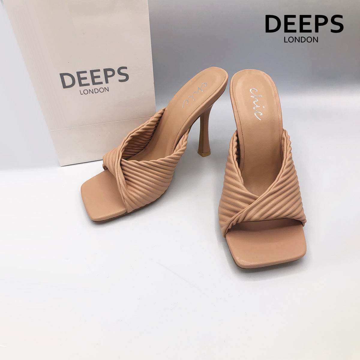 Close-up detail of Dasha folded mule ribbed high heel in mocha, showcasing the intricate folded and ribbed leather texture, London style from DeepsLondon.