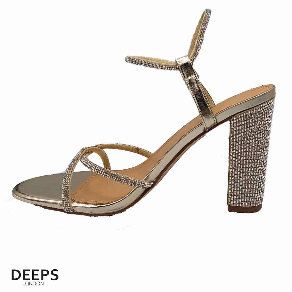 Close-up of the diamante detailing on the heel and strap, and the buckle fastening, of women's block heel sandals in gold, highlighting their elegant features from DeepsLondon.
