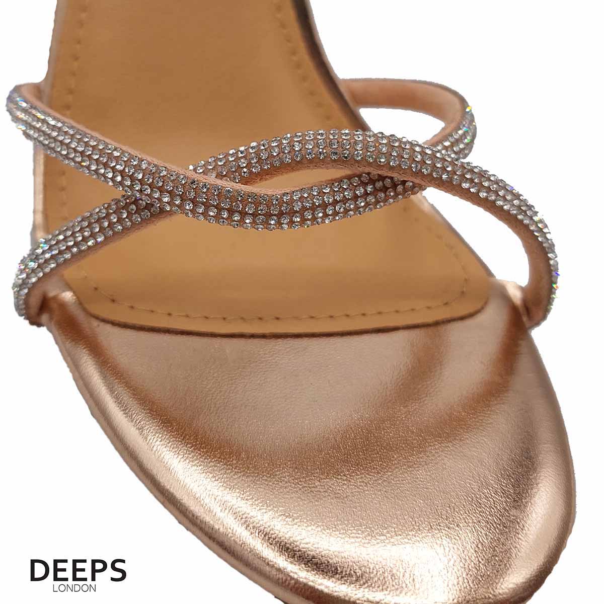 Close-up of the diamante detailing on the heel and strap, and the buckle fastening, of women's block heel sandals in rose gold, highlighting their elegant features from DeepsLondon.