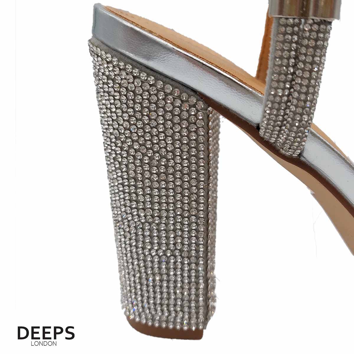 Close-up of the diamante detailing on the heel and strap, and the buckle fastening, of women's block heel sandals in silver, highlighting their elegant features from DeepsLondon.