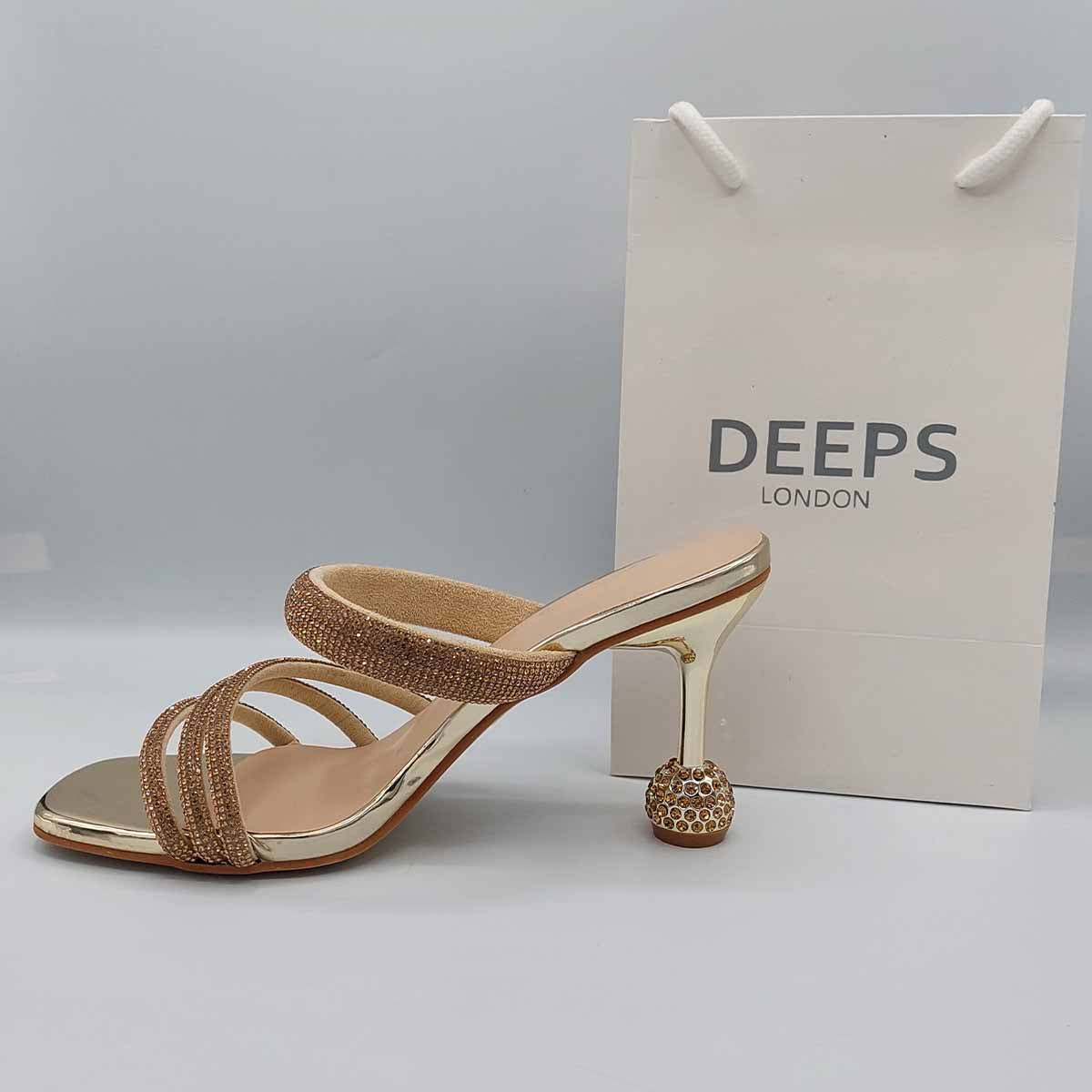 Woman's foot wearing stylish diamante strappy round heel mule sandals in gold, a comfortable and fashionable choice for London evenings from DeepsLondon.