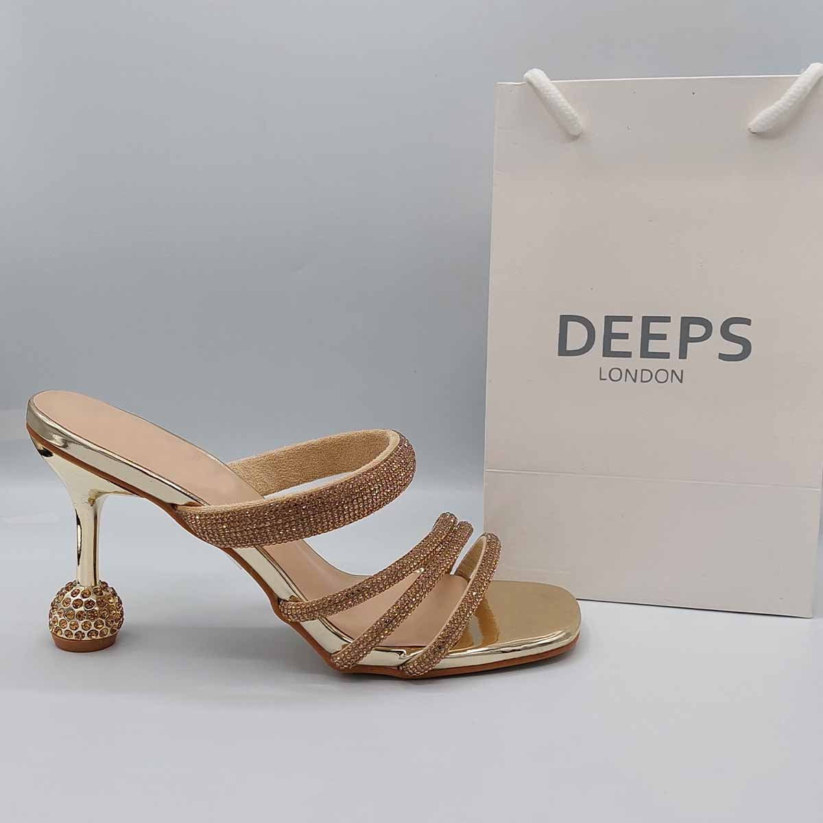 Side profile of women's diamante strappy round heel mule sandals in gold, showcasing the elegant straps, sparkling diamante detailing, and round heel for London fashion.
