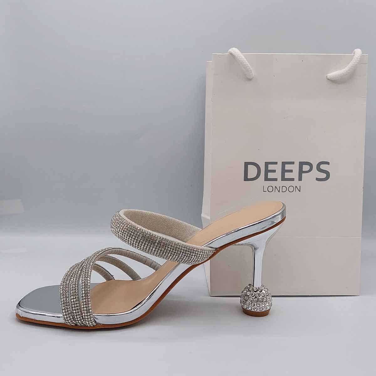 Woman's foot wearing stylish diamante strappy round heel mule sandals in silver, a comfortable and fashionable choice for London evenings from DeepsLondon.