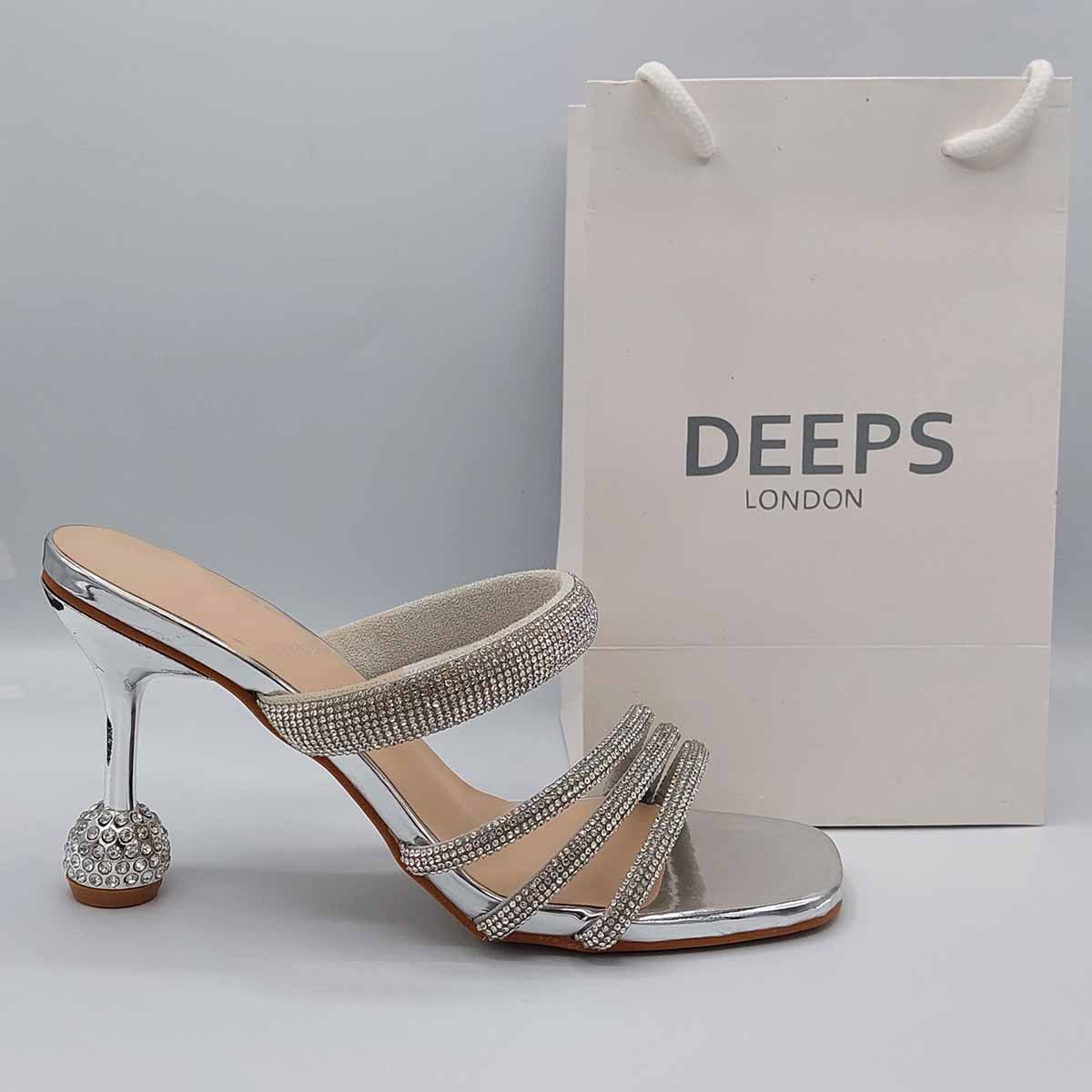 Side profile of women's diamante strappy round heel mule sandals in silver, showcasing the elegant straps, sparkling diamante detailing, and round heel for London fashion.