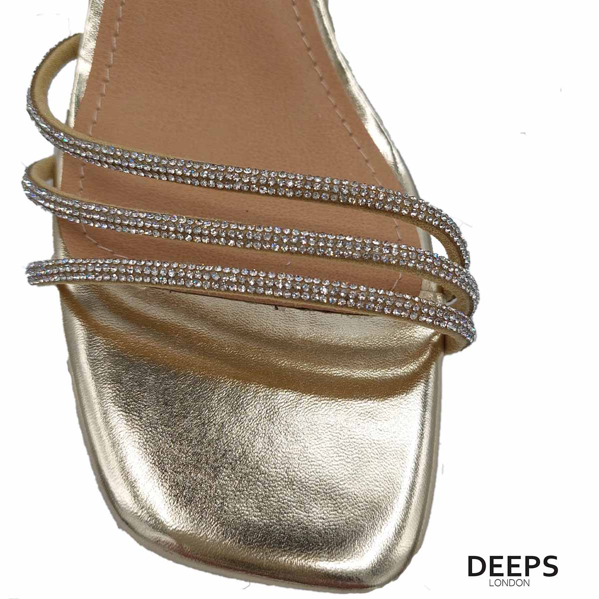 Close-up of the diamante detailing on the triple front straps and the block heel of women's open back sandals in gold, highlighting their elegant features for London evenings.