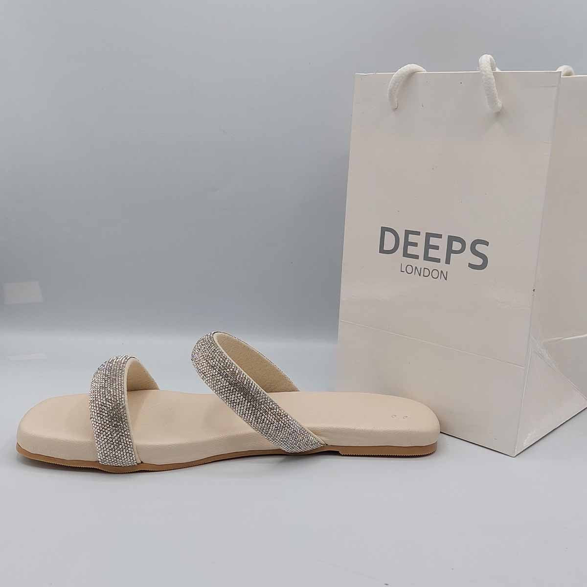 Front view of women's double strap flat slider sandals in beige with sparkly embellishments, a glamorous choice for London.