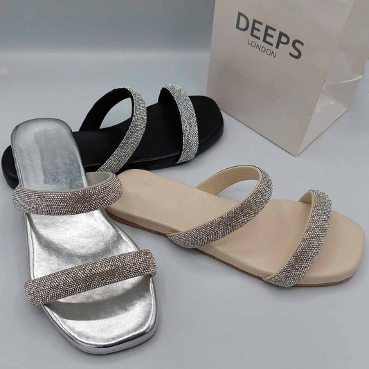Front view of women's double strap flat slider sandals in black, silver and beige with sparkly embellishments, a glamorous choice for London.