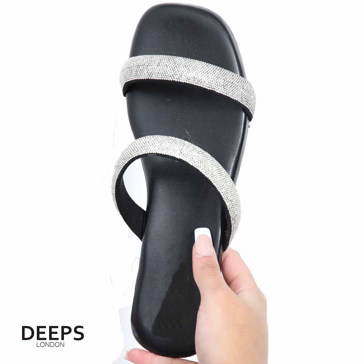 Woman's foot wearing stylish double strap embellished flat slider sandals in black, a comfortable and fashionable choice for London life from DeepsLondon.