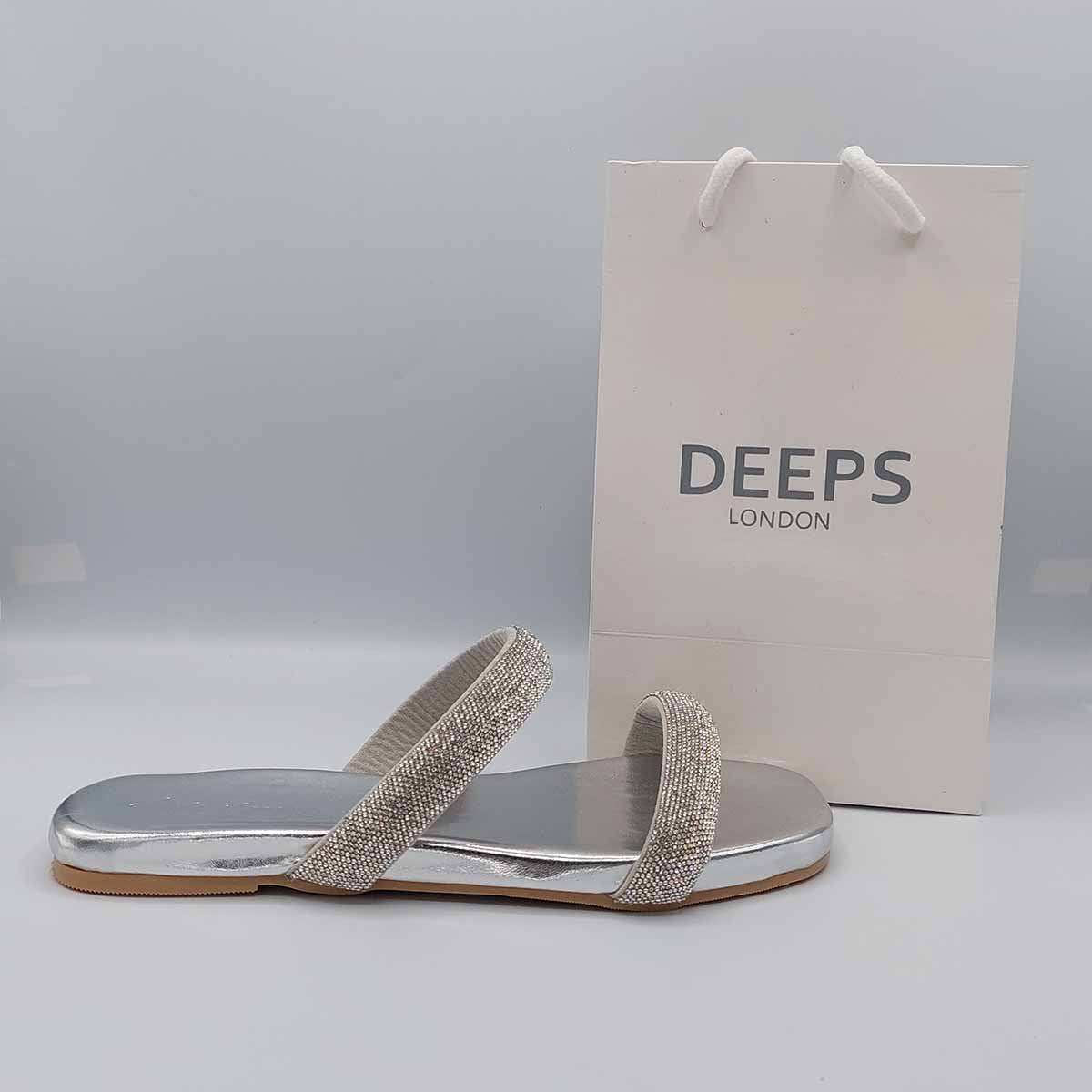 Front view of women's double strap flat slider sandals in silver with sparkly embellishments, a glamorous choice for London.