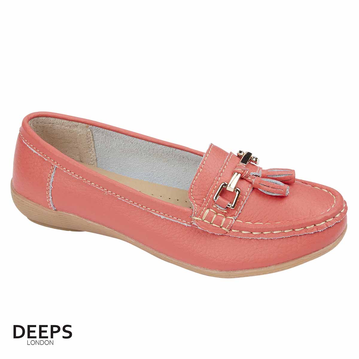 Woman's foot wearing stylish leather slip-on casual shoe in coral with tassels, a comfortable and fashionable choice for London life from DeepsLondon.