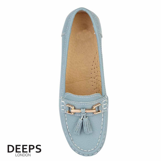 Side profile of women's leather slip-on mocassin/boat shoe in light blue with tassels, showcasing its comfortable design for London wear.