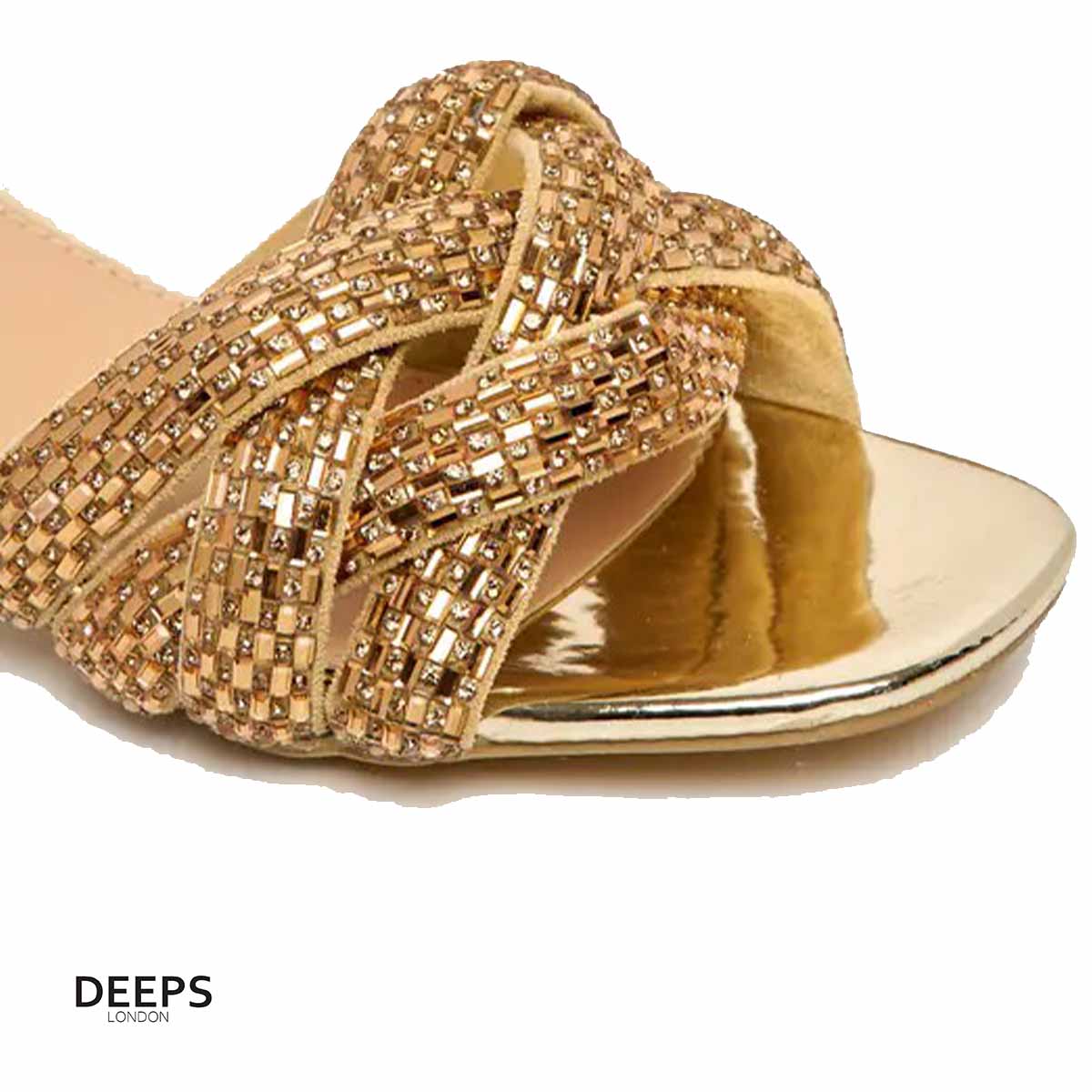 Close-up of the gemstone embellishments on Lenora plaited block heel mules in gold, showcasing the exquisite sparkle, London style from DeepsLondon.
