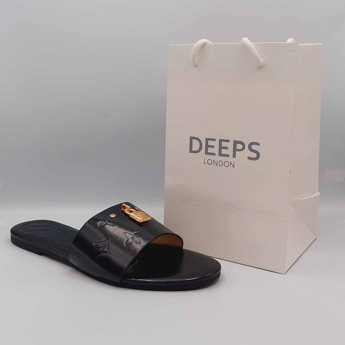 Close-up of the gold lock detail on the strap of women's open toe flat slider sandals in black, highlighting their unique and stylish feature from DeepsLondon.