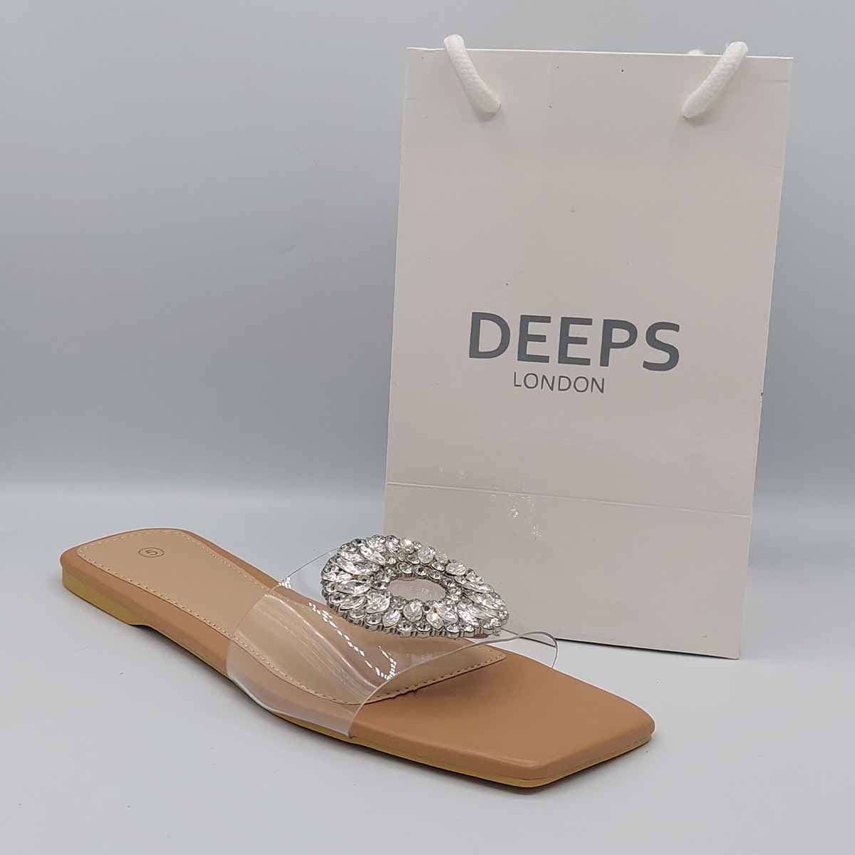 Side profile of women's beige perspex flat slider sandals showcasing the diamante detail on the transparent strap, perfect for London fashion.