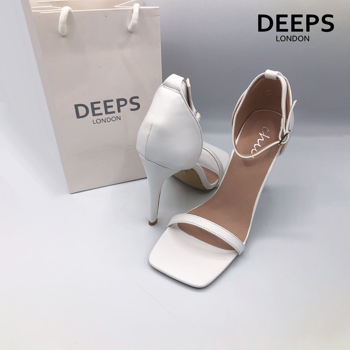 Front view of women's Radius square toe high heels with buckle ankle strap in white, sharp London style from DeepsLondon.