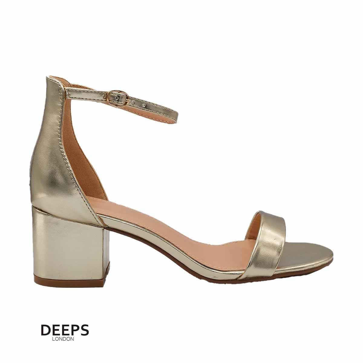 Side profile of women's Regent block heel buckle strap sandals in gold, showcasing the block heel and buckle strap detailing for London fashion.