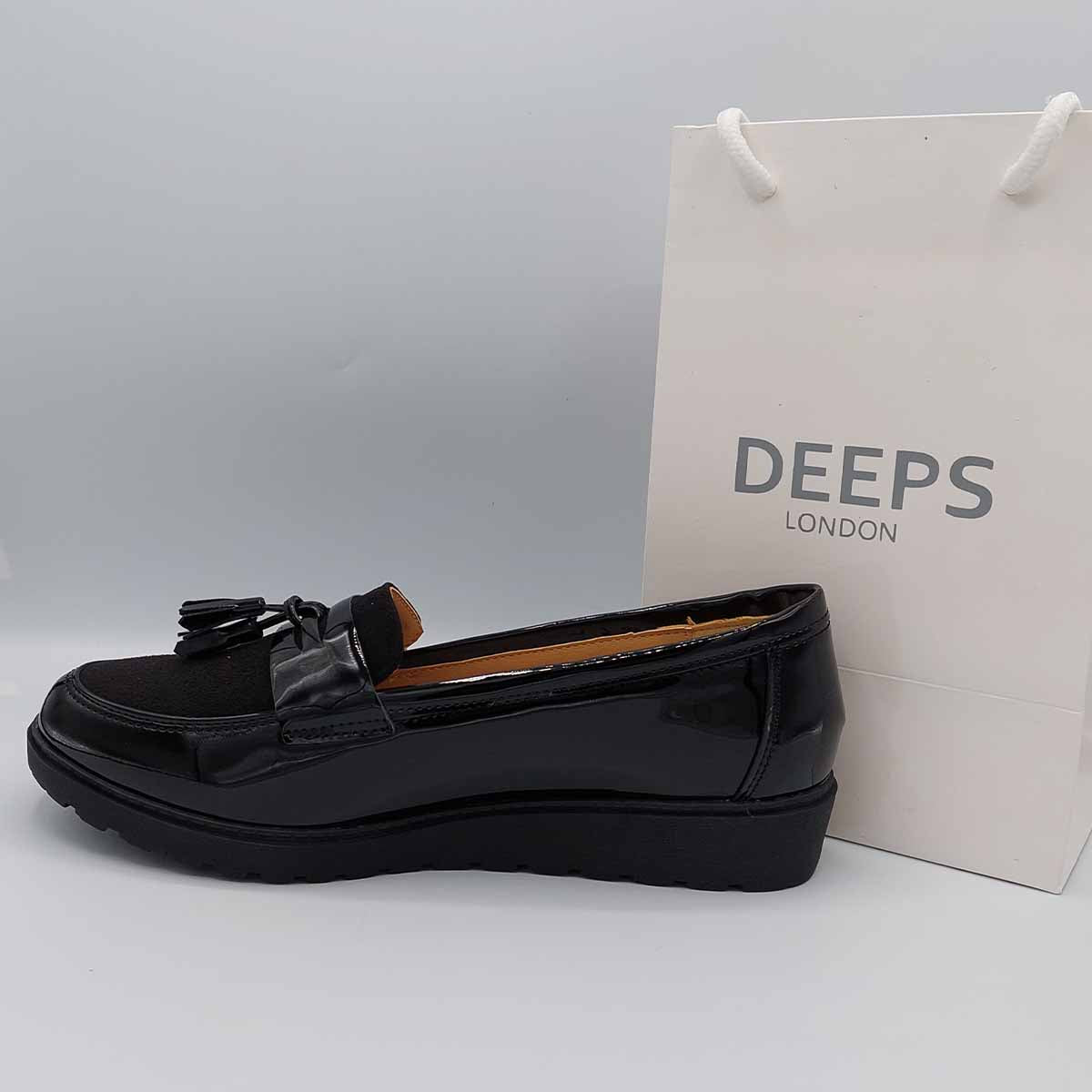 Close-up of the fringe and tassel detailing and the chunky sole on women's wide fit black patent loafers, emphasizing their unique design for London fashion.