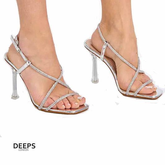 Close-up of the diamante embellishments and clear perspex heel on women's Wilde stiletto heels in silver, highlighting their bold and glamorous features from DeepsLondon.