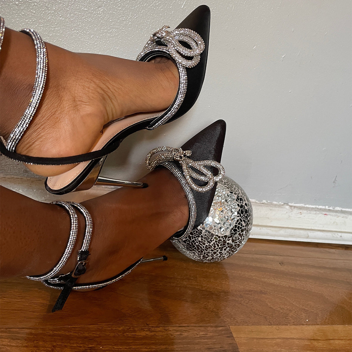 Side profile of Zala double bow court heels in black satin, highlighting the classic court shoe design and heel, London style from DeepsLondon.